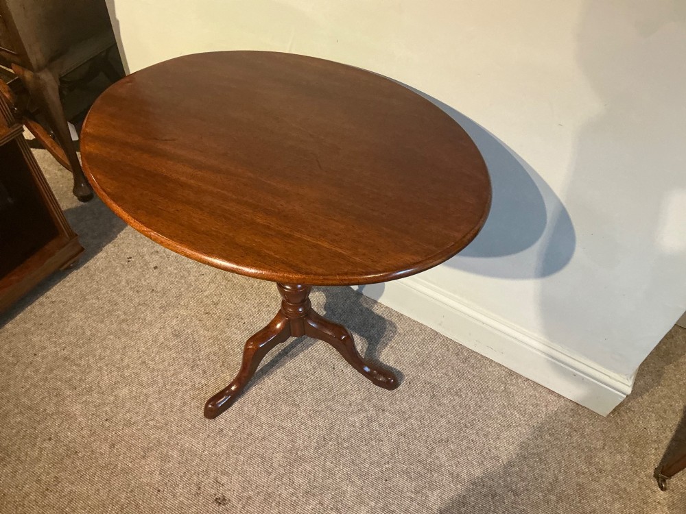A circular mahogany tripod table featuring a turned central pedestal supported by three cabriole legs ending in pad feet. View II