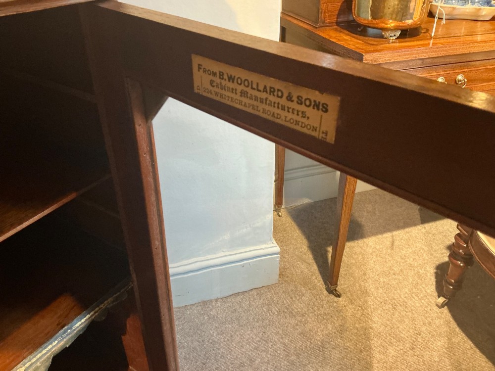 A Victorian burr walnut music cabinet featuring inlaid boxwood stringing, a top drawer, a glazed door revealing internal shelves and vertical dividers, and a brass gallery rail. View VI