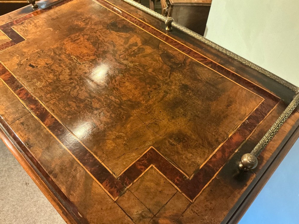 A Victorian burr walnut music cabinet featuring inlaid boxwood stringing, a top drawer, a glazed door revealing internal shelves and vertical dividers, and a brass gallery rail. View VIII