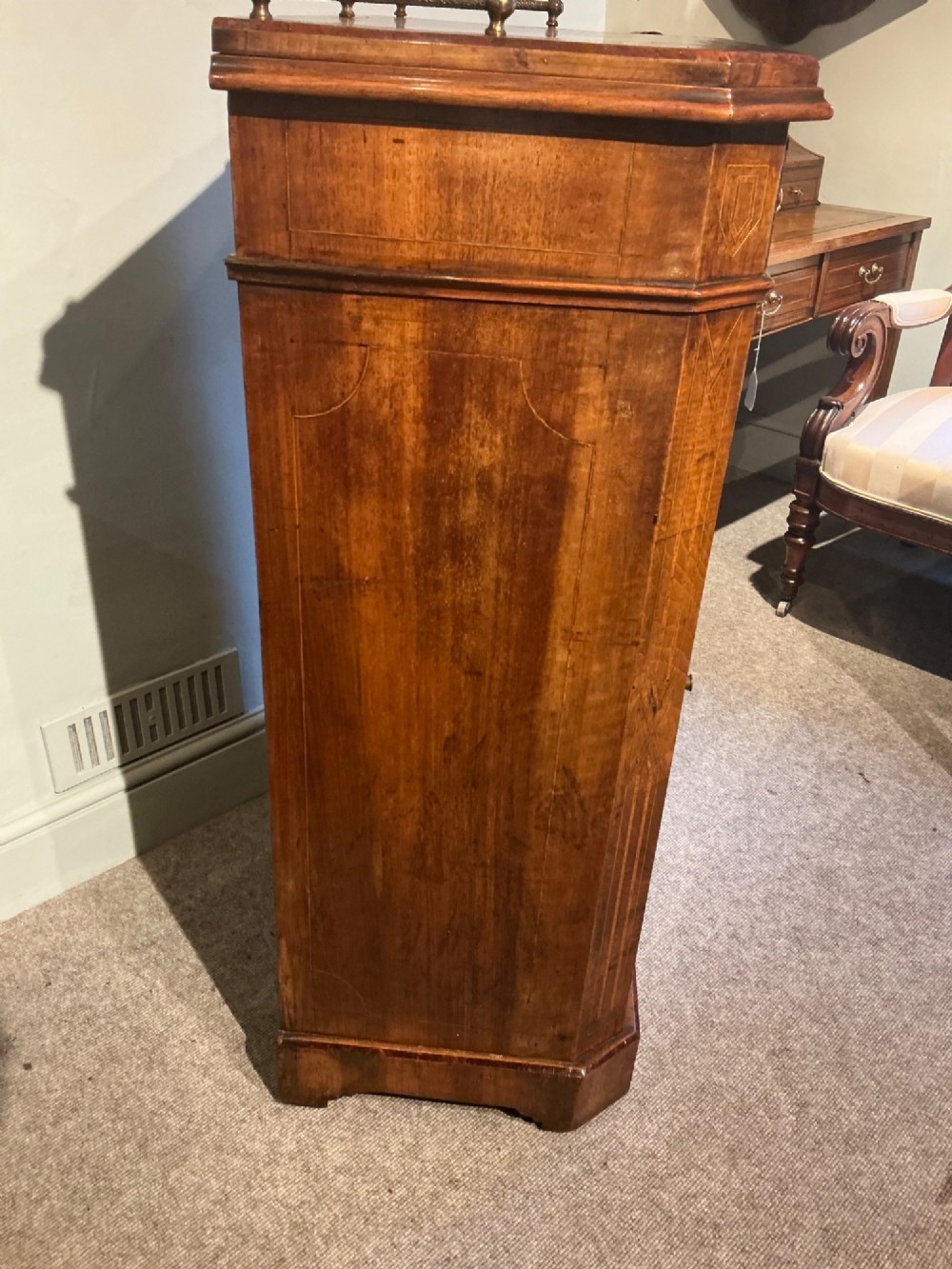 A Victorian burr walnut music cabinet featuring inlaid boxwood stringing, a top drawer, a glazed door revealing internal shelves and vertical dividers, and a brass gallery rail. View IX