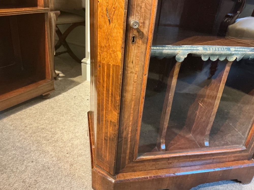 A Victorian burr walnut music cabinet featuring inlaid boxwood stringing, a top drawer, a glazed door revealing internal shelves and vertical dividers, and a brass gallery rail. View XI