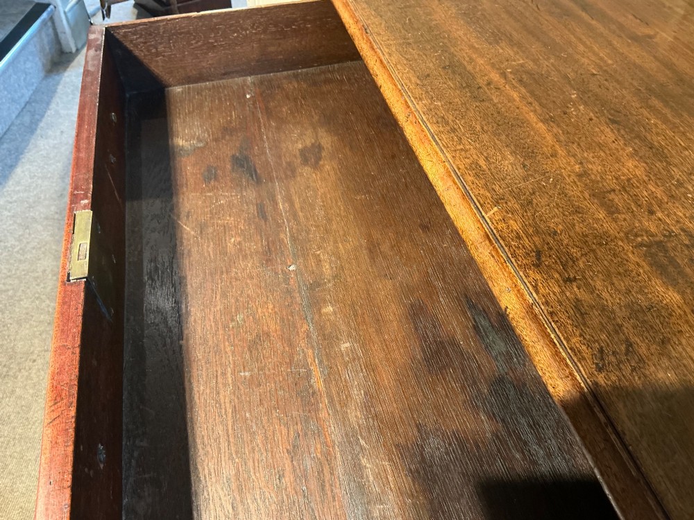 A Georgian mahogany chest of drawers featuring four graduated drawers with brass swan-neck handles and bracket feet. View VII