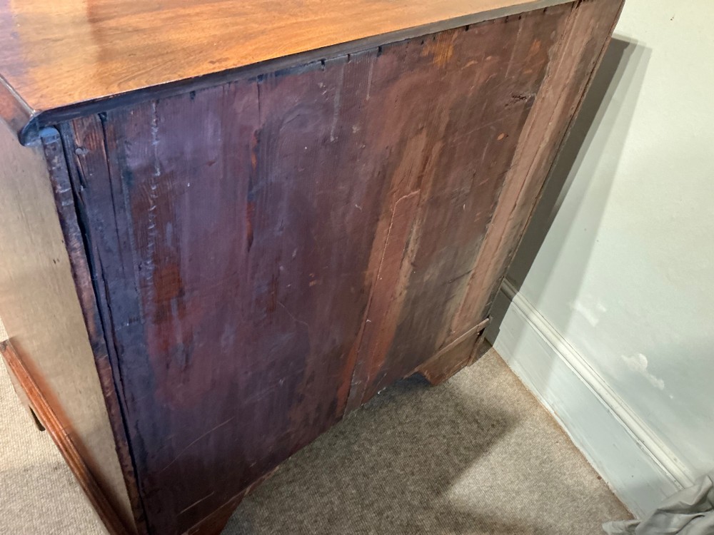 A Georgian mahogany chest of drawers featuring four graduated drawers with brass swan-neck handles and bracket feet. View IX