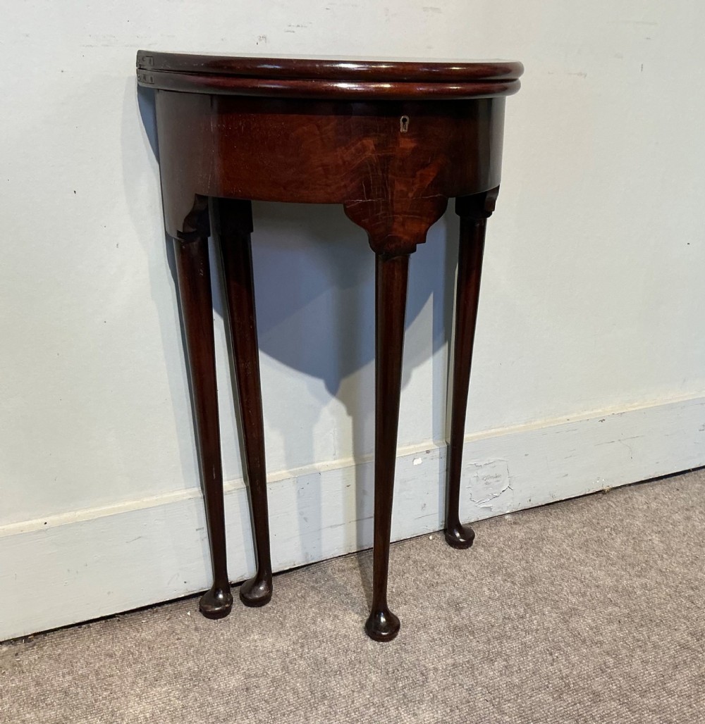 A dark mahogany demi-lune fold-over tea table with slender tapered legs, pad feet, and a brass keyhole escutcheon on the apron. View IV