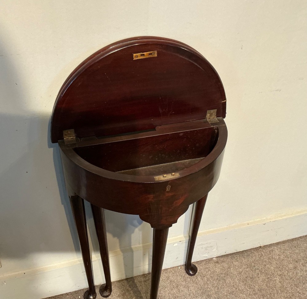 A dark mahogany demi-lune fold-over tea table with slender tapered legs, pad feet, and a brass keyhole escutcheon on the apron. View IX