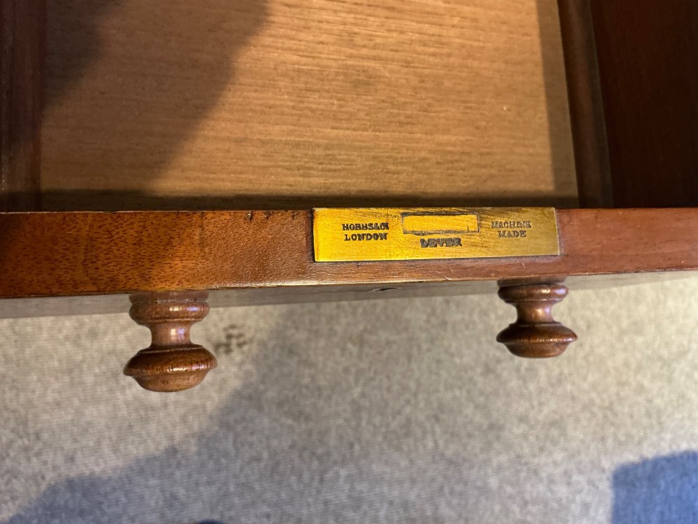 An antique oak pedestal desk featuring a rectangular leather inset top, nine drawers with turned wooden knobs, and twin plinth bases. View VIII