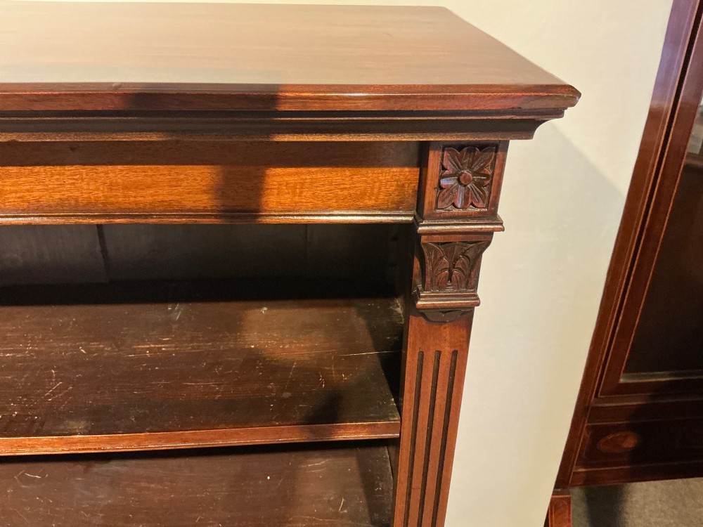 An antique mahogany open bookcase featuring four fixed shelves, fluted side pilasters with carved rosette capitals, and a solid plinth base. View IV