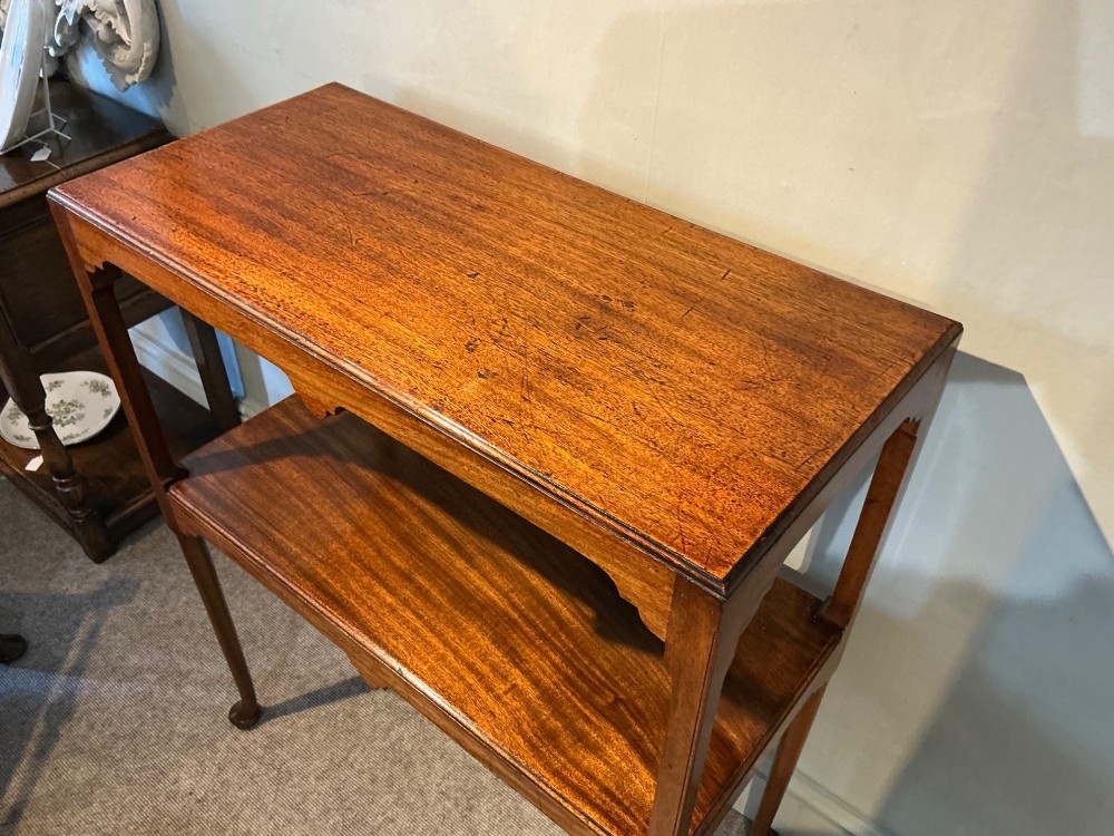 A rectangular mahogany two-tier occasional table with slender legs, pad feet, and shaped aprons. View III