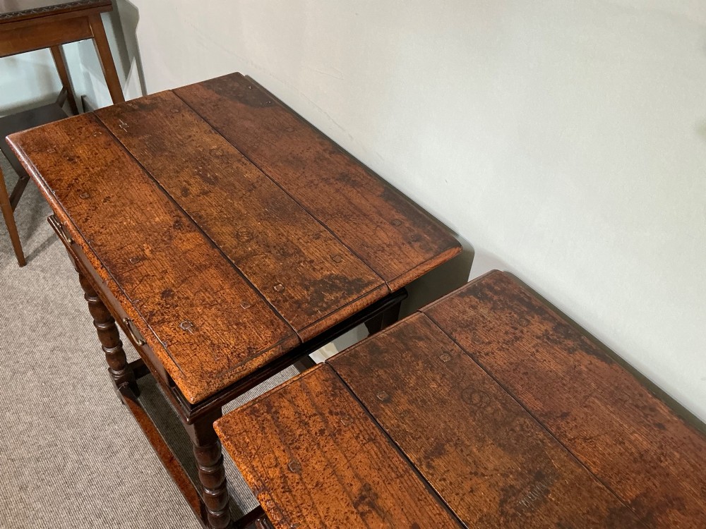 A matching pair of dark brown oak side tables featuring single frieze drawers with brass handles, turned legs, and square perimeter stretchers. View VII