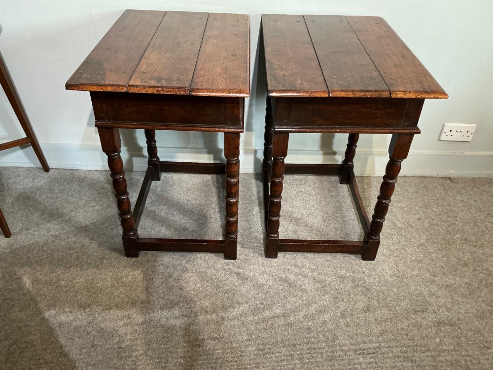 A matching pair of dark brown oak side tables featuring single frieze drawers with brass handles, turned legs, and square perimeter stretchers. View VIII