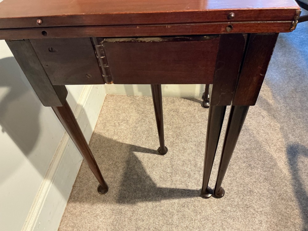 A dark mahogany demi-lune console table featuring a fold-over top, straight apron, and slender tapered legs ending in pad feet. View VI