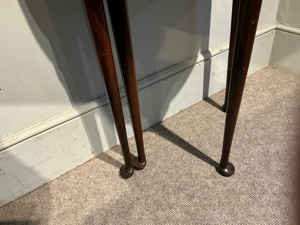 A dark mahogany demi-lune console table featuring a fold-over top, straight apron, and slender tapered legs ending in pad feet. View VII