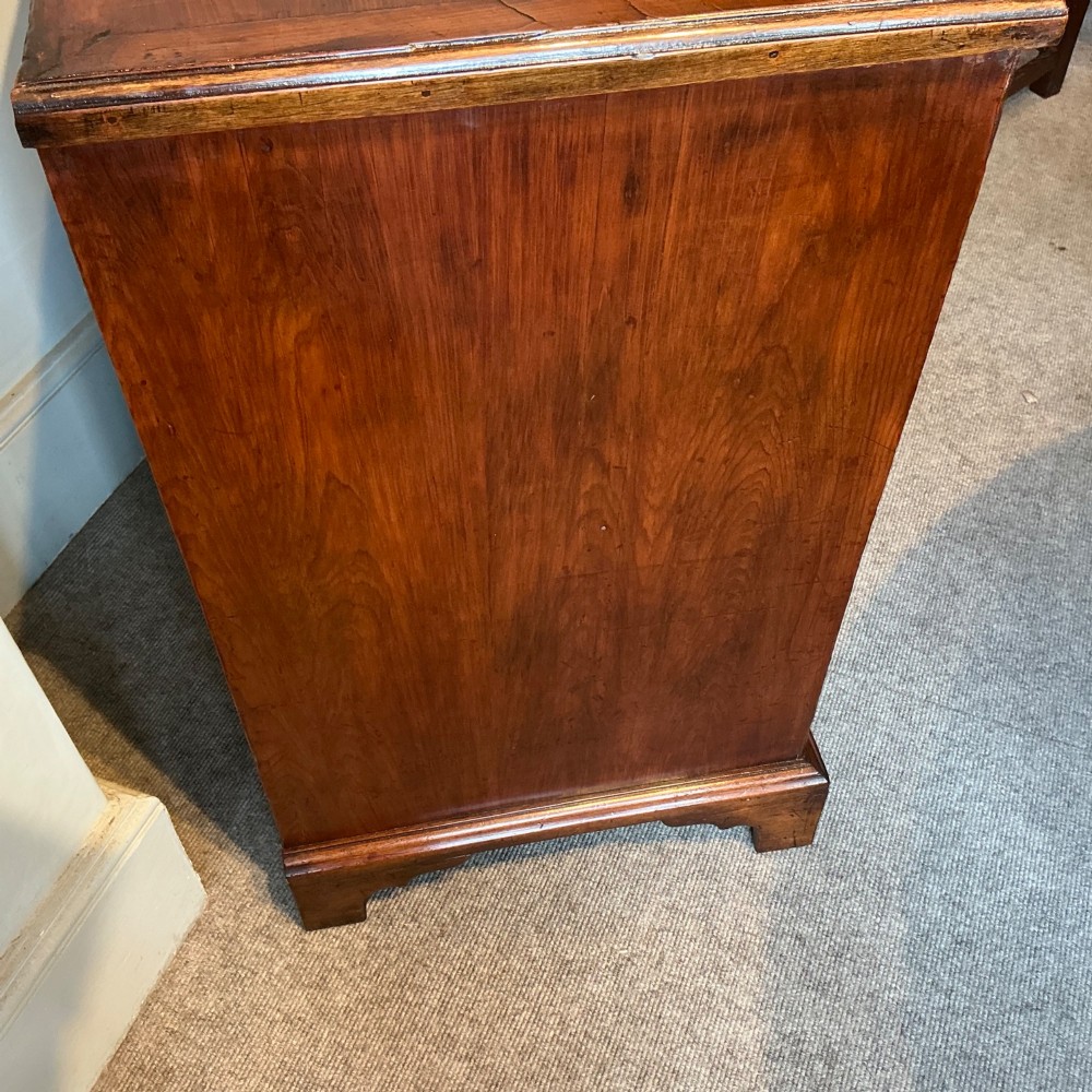 A Georgian cedar wood chest of drawers featuring multiple drawer compartments, brass swan-neck handles, and bracket feet. View VIII