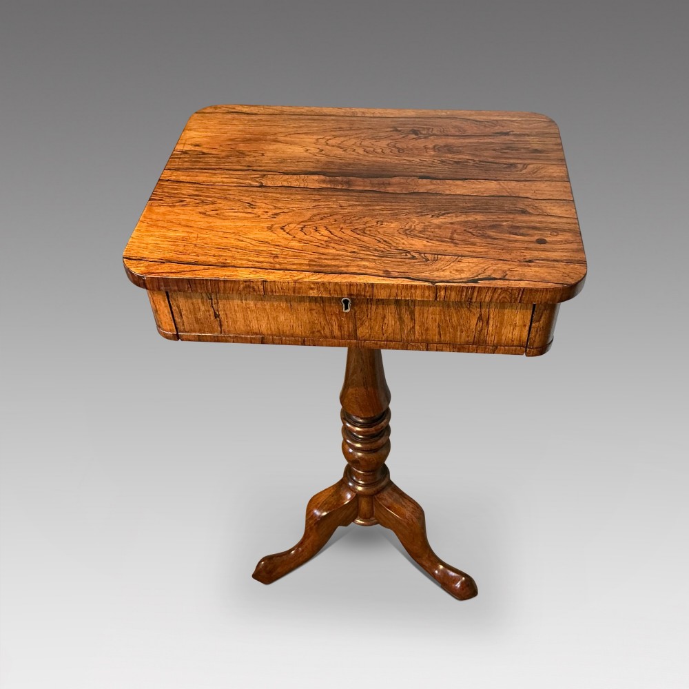 An antique rosewood pedestal table featuring a rectangular top with rounded corners, a keyhole in the frieze, a turned central stem, and a tripod base. View II
