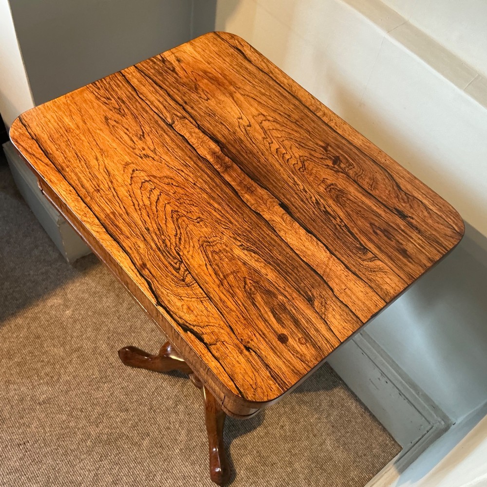 An antique rosewood pedestal table featuring a rectangular top with rounded corners, a keyhole in the frieze, a turned central stem, and a tripod base. View III