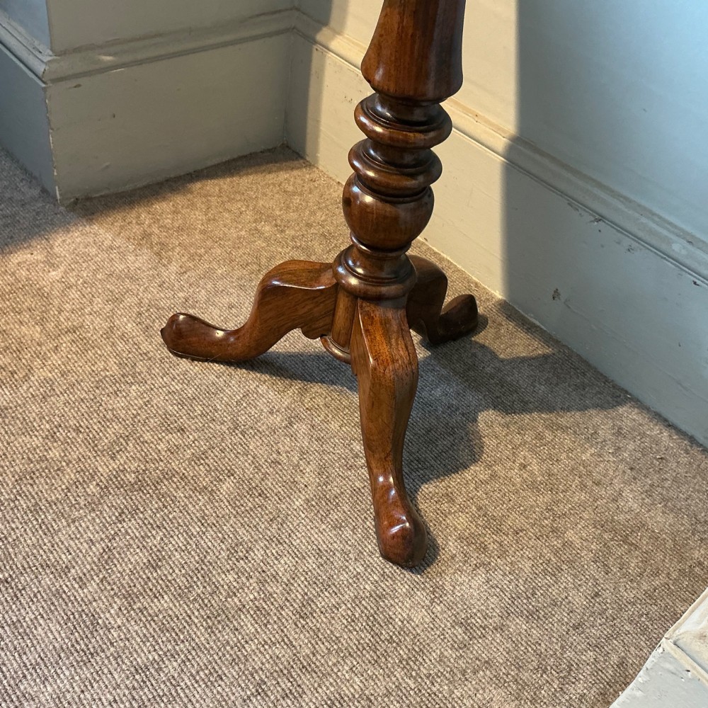 An antique rosewood pedestal table featuring a rectangular top with rounded corners, a keyhole in the frieze, a turned central stem, and a tripod base. View IV