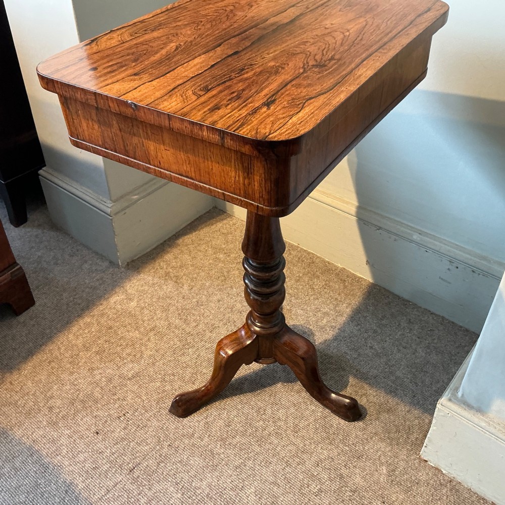 An antique rosewood pedestal table featuring a rectangular top with rounded corners, a keyhole in the frieze, a turned central stem, and a tripod base. View VI