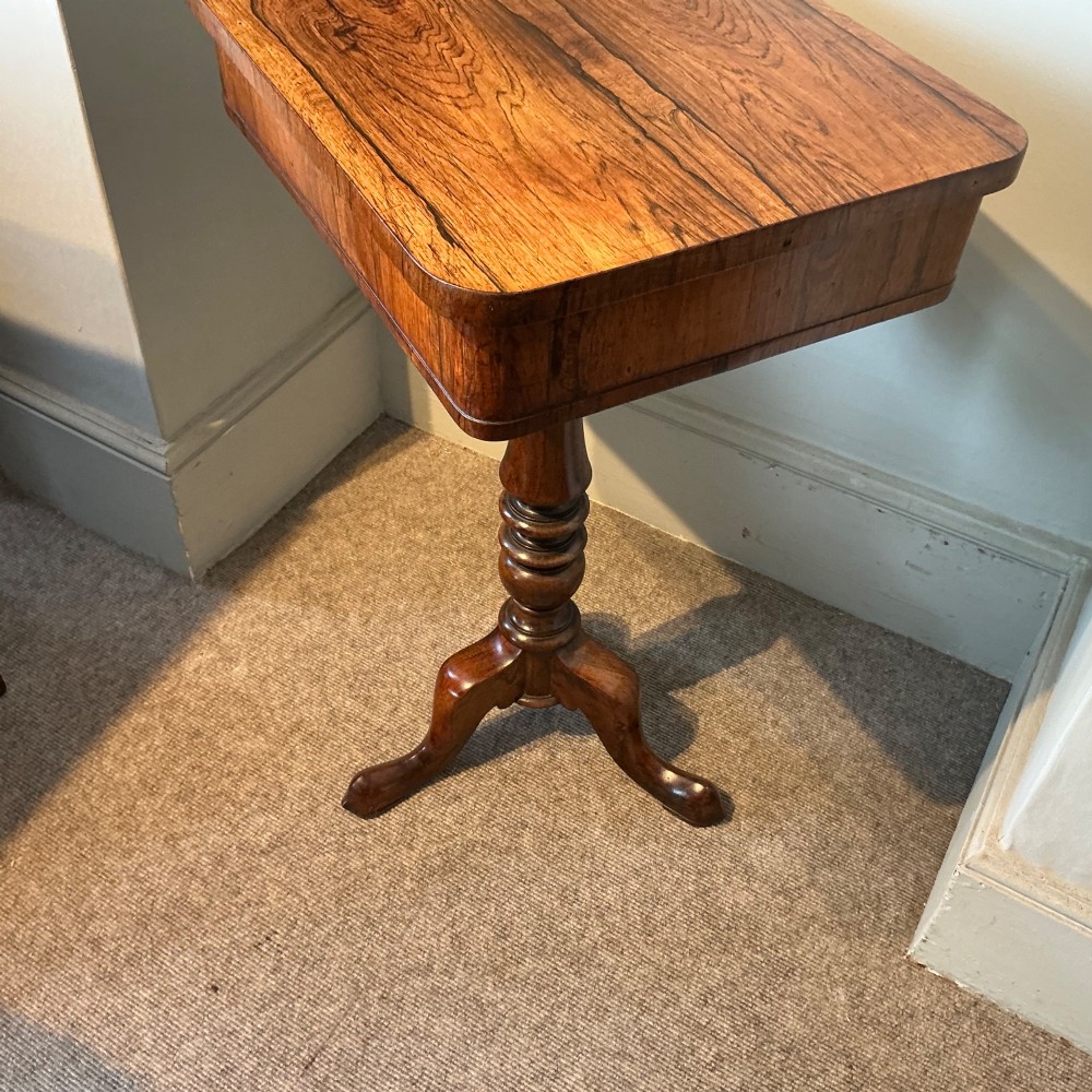 An antique rosewood pedestal table featuring a rectangular top with rounded corners, a keyhole in the frieze, a turned central stem, and a tripod base. View VII