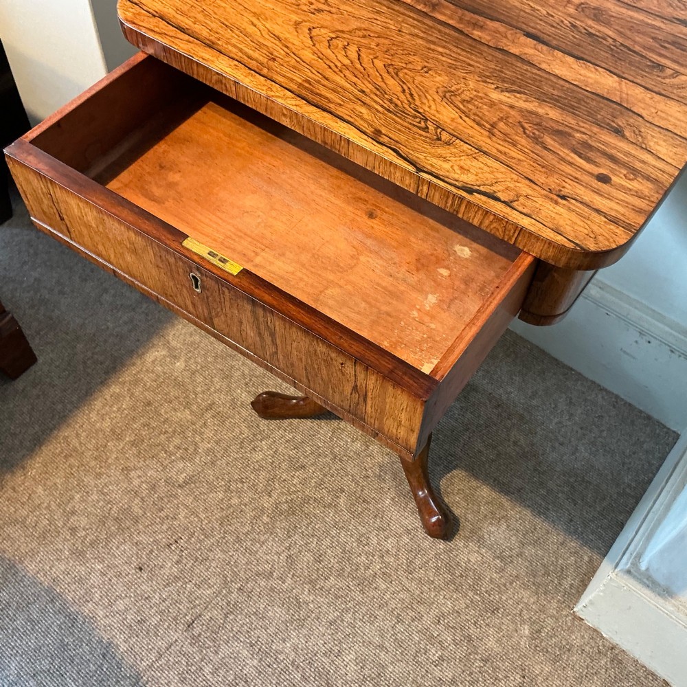 An antique rosewood pedestal table featuring a rectangular top with rounded corners, a keyhole in the frieze, a turned central stem, and a tripod base. View VIII