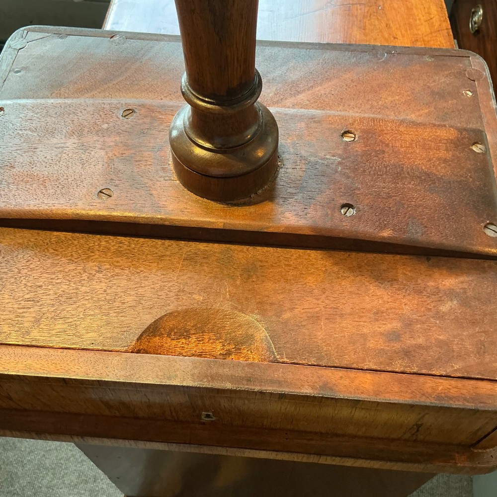An antique rosewood pedestal table featuring a rectangular top with rounded corners, a keyhole in the frieze, a turned central stem, and a tripod base. View IX