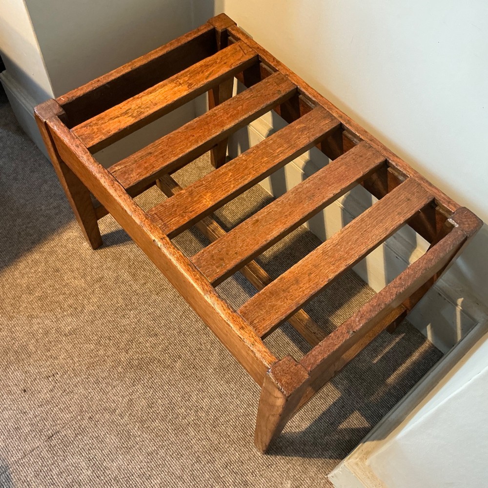 A solid oak antique luggage rack featuring five rectangular top slats supported by square legs and cross stretchers. View III