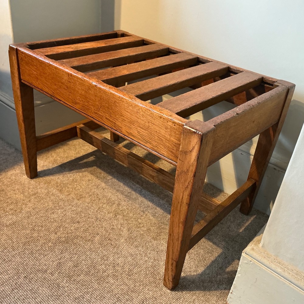 A solid oak antique luggage rack featuring five rectangular top slats supported by square legs and cross stretchers. View IV