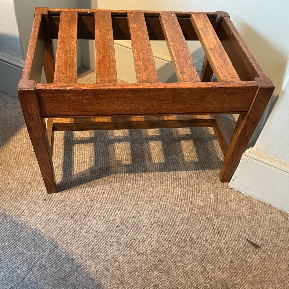 A solid oak antique luggage rack featuring five rectangular top slats supported by square legs and cross stretchers. View VI