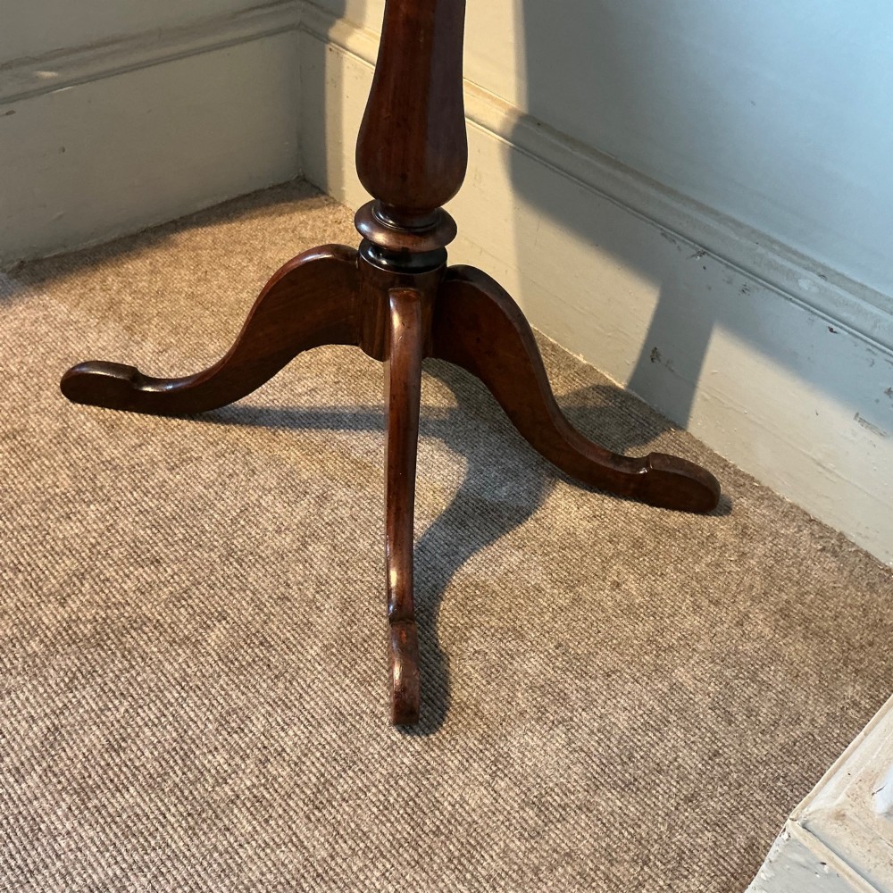 An antique dark wood pedestal chess table featuring an inlaid checkerboard surface top and a turned stem on four splayed legs. View V