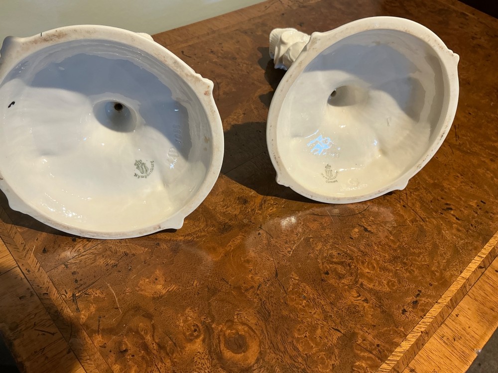 A pair of white glazed porcelain candlesticks featuring ornate Rococo relief moulding and scrollwork bases. View VII