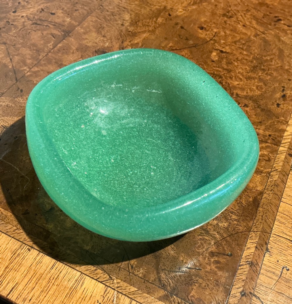 A rounded square green Murano glass dish with thick walls and visible internal micro-bubbles. View II