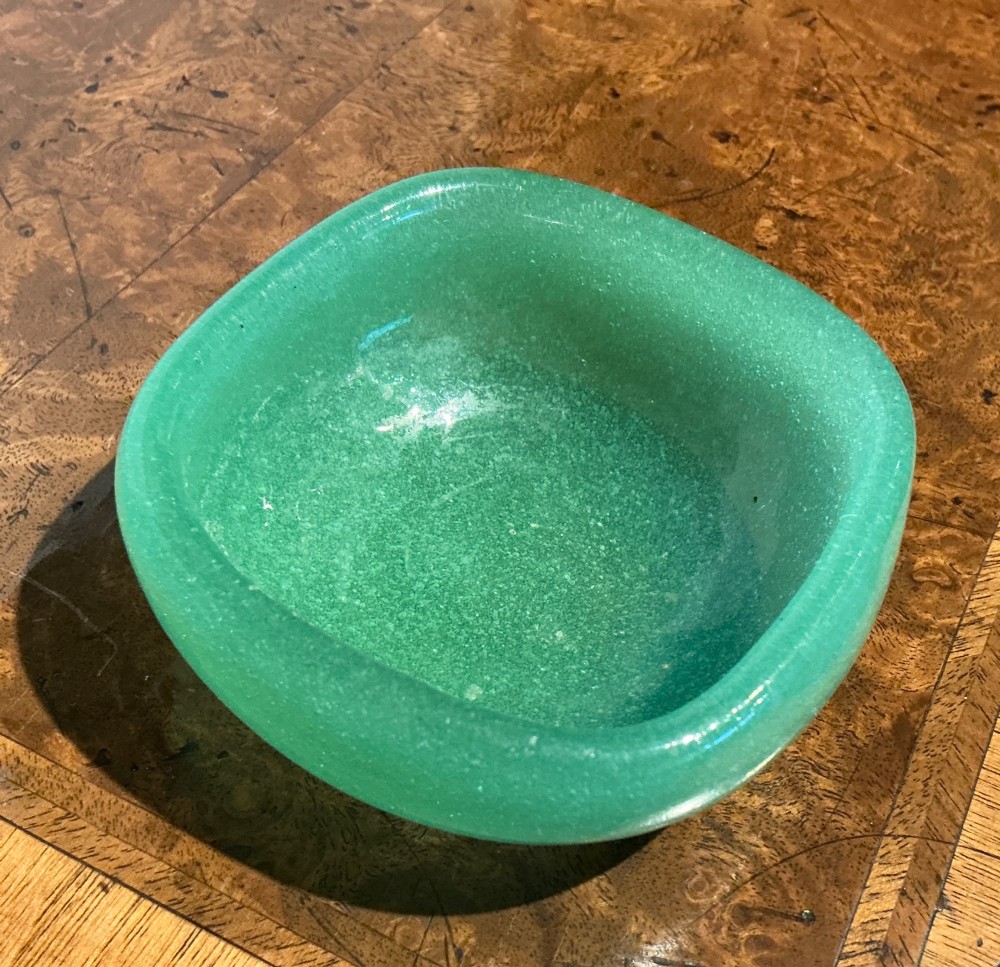 A rounded square green Murano glass dish with thick walls and visible internal micro-bubbles. View III