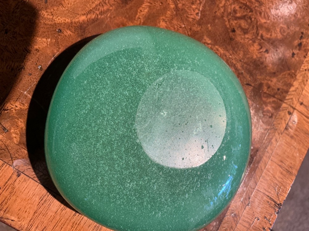 A rounded square green Murano glass dish with thick walls and visible internal micro-bubbles. View V
