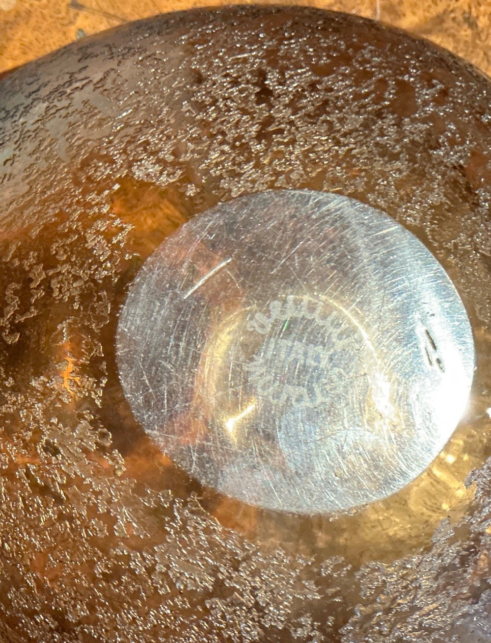 A small rounded square smoky brown blown glass bowl with an acid-etched corroso textured exterior and smooth polished interior. View IV