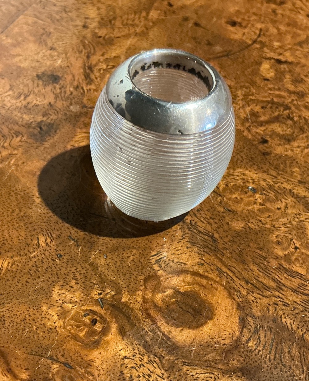 A globular glass match striker featuring a ribbed clear glass body and a hallmarked sterling silver collar around the top opening. View III