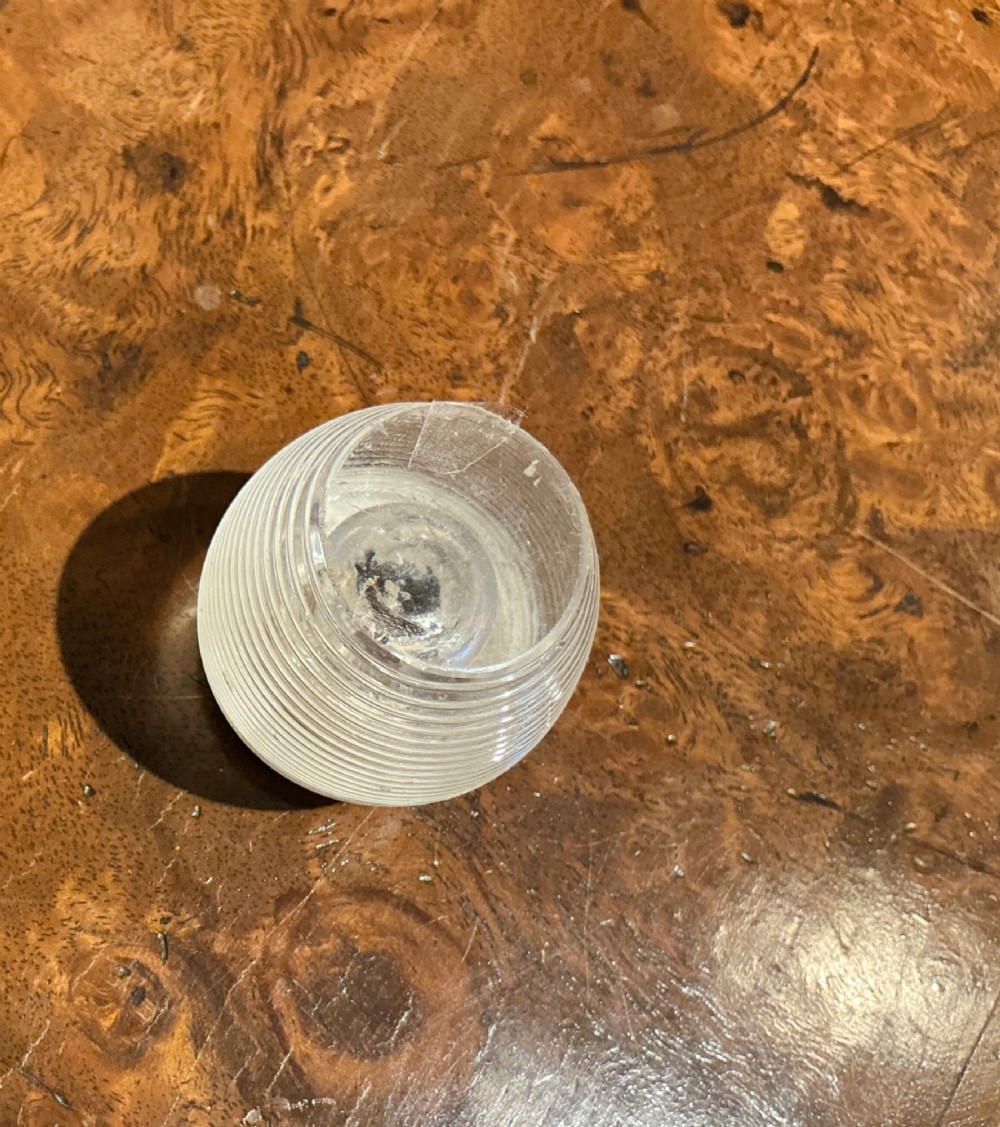 A globular glass match striker featuring a ribbed clear glass body and a hallmarked sterling silver collar around the top opening. View V