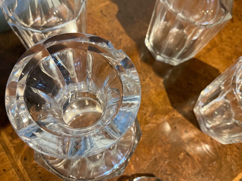 A set of four matching clear cut crystal liqueur decanters featuring panelled bodies and facet-cut stoppers. View VII