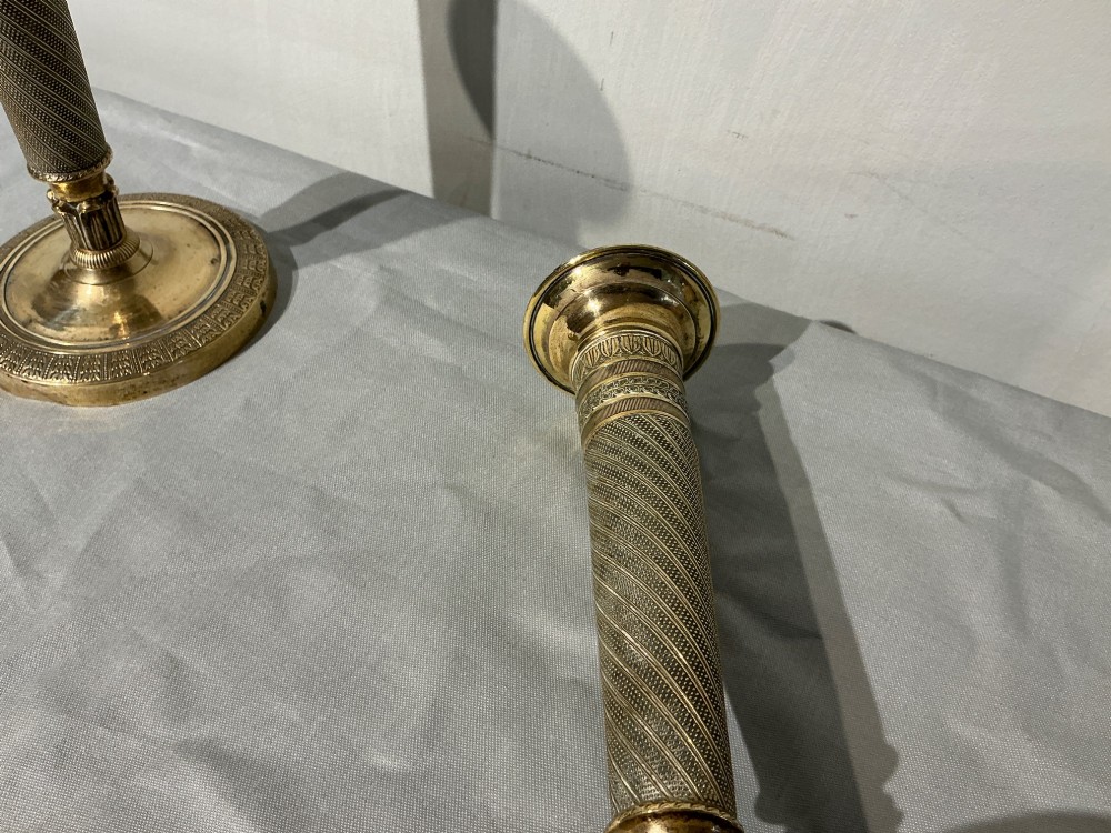 A pair of French Empire brass candlesticks with spiralled engine-turned shafts and circular bases. View VI