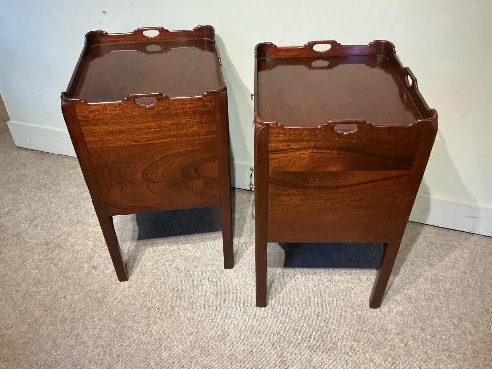 A pair of mahogany bedside cabinets featuring tray tops with gallery handles, slatted tambour cupboard doors, single drawers with brass handles, and square straight legs. View V