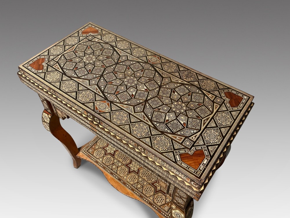 An antique Syrian Damascus games table featuring intricate geometric mother-of-pearl and wood inlay with cabriole legs and a matching lower shelf. View II