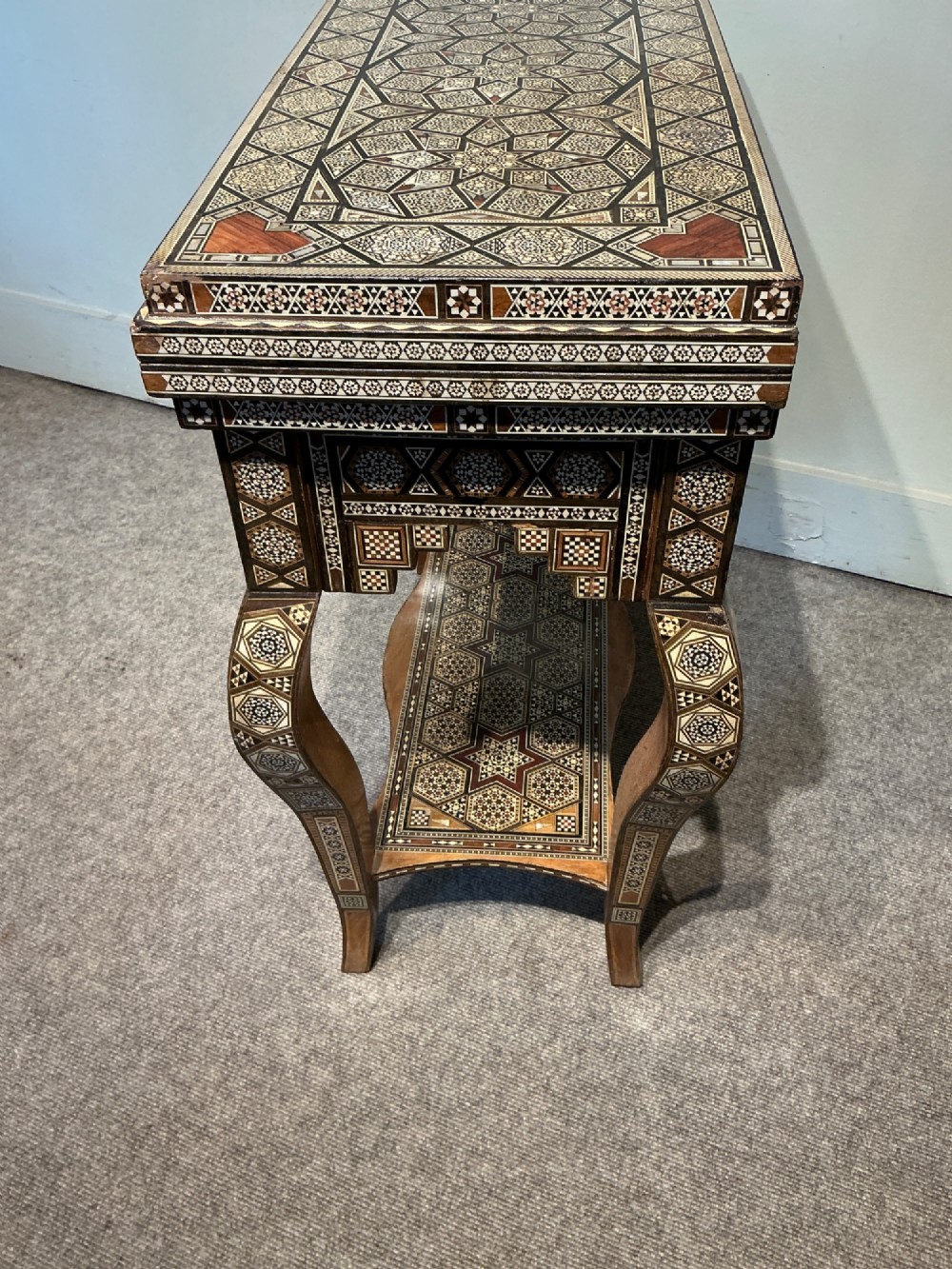 An antique Syrian Damascus games table featuring intricate geometric mother-of-pearl and wood inlay with cabriole legs and a matching lower shelf. View V