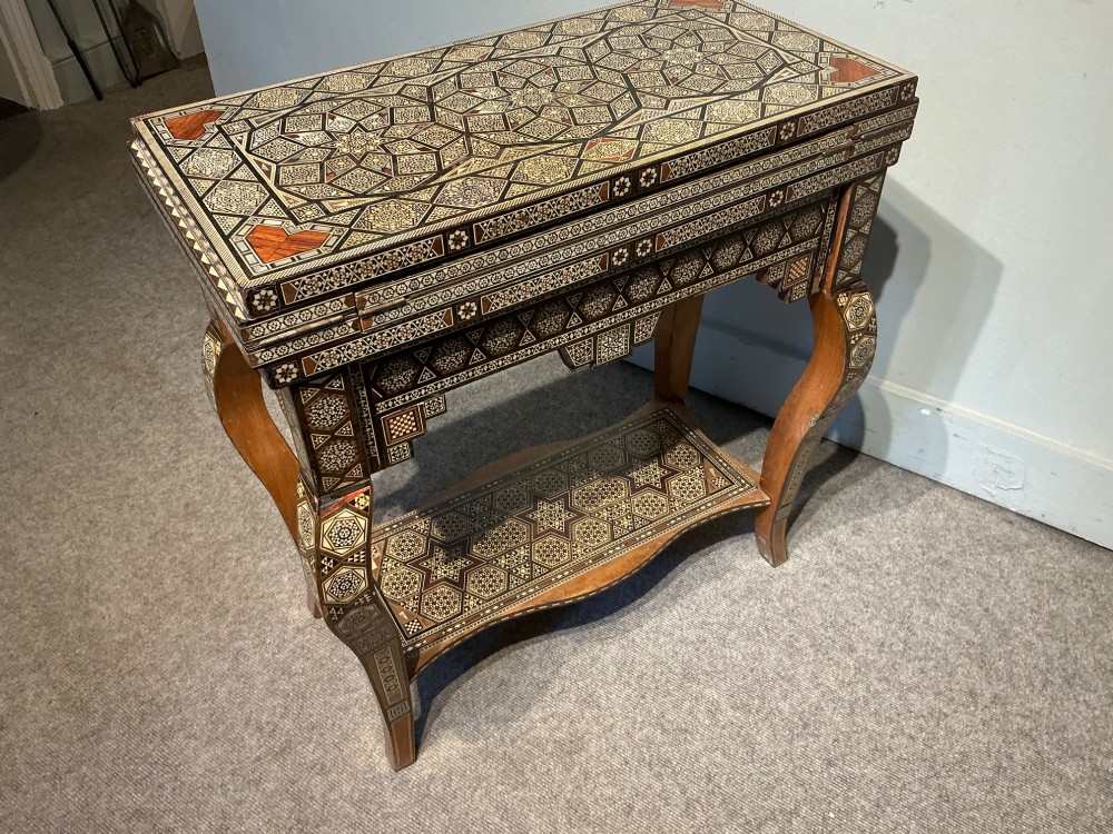 An antique Syrian Damascus games table featuring intricate geometric mother-of-pearl and wood inlay with cabriole legs and a matching lower shelf. View VI