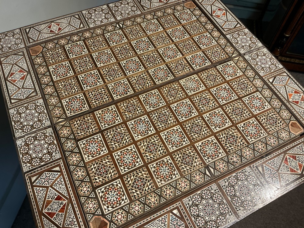 An antique Syrian Damascus games table featuring intricate geometric mother-of-pearl and wood inlay with cabriole legs and a matching lower shelf. View XI