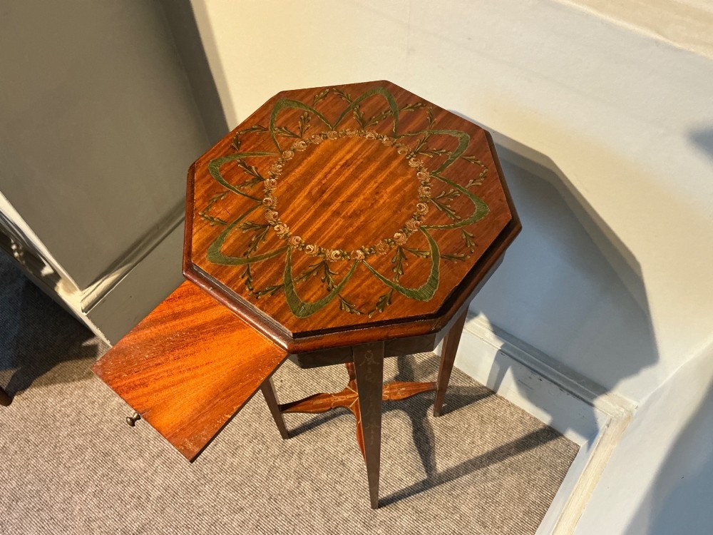 An octagonal antique satinwood urn stand featuring hand-painted floral garlands, a pull-out slide, slender tapered legs, and an X-shaped cross stretcher. View IV