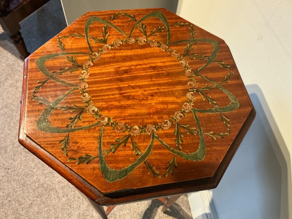 An octagonal antique satinwood urn stand featuring hand-painted floral garlands, a pull-out slide, slender tapered legs, and an X-shaped cross stretcher. View V