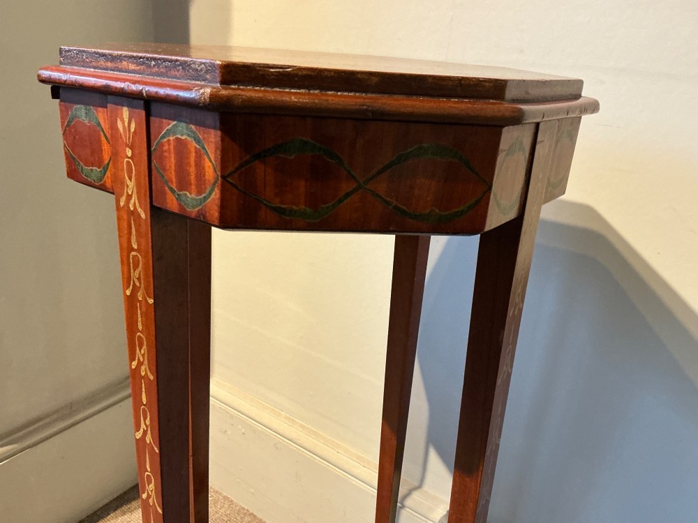 An octagonal antique satinwood urn stand featuring hand-painted floral garlands, a pull-out slide, slender tapered legs, and an X-shaped cross stretcher. View VII
