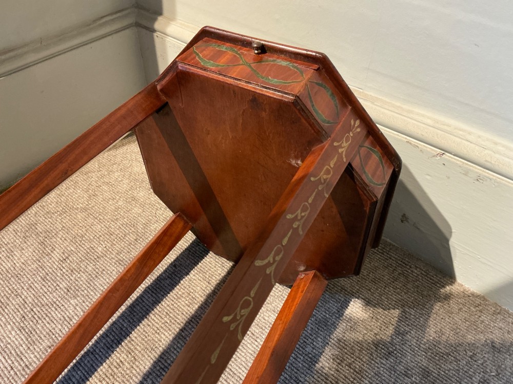 An octagonal antique satinwood urn stand featuring hand-painted floral garlands, a pull-out slide, slender tapered legs, and an X-shaped cross stretcher. View IX