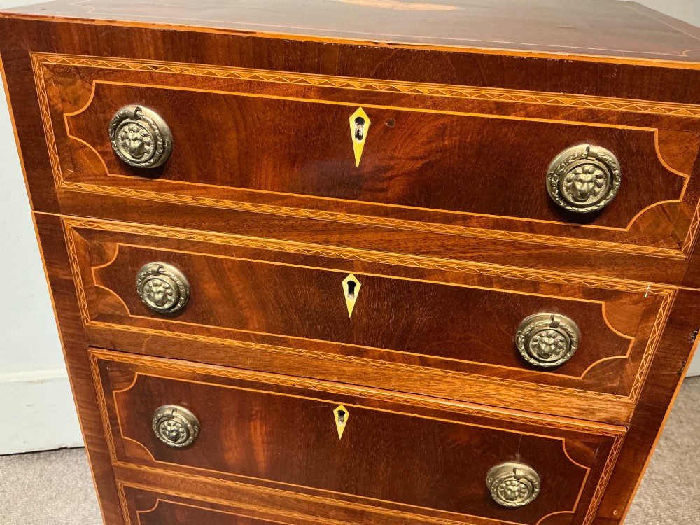 A nineteenth-century mahogany work table featuring satinwood inlay, bone escutcheons, brass ring handles, four drawer fronts, and turned legs on brass castors. View V