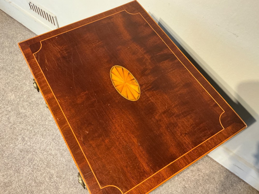 A nineteenth-century mahogany work table featuring satinwood inlay, bone escutcheons, brass ring handles, four drawer fronts, and turned legs on brass castors. View VII