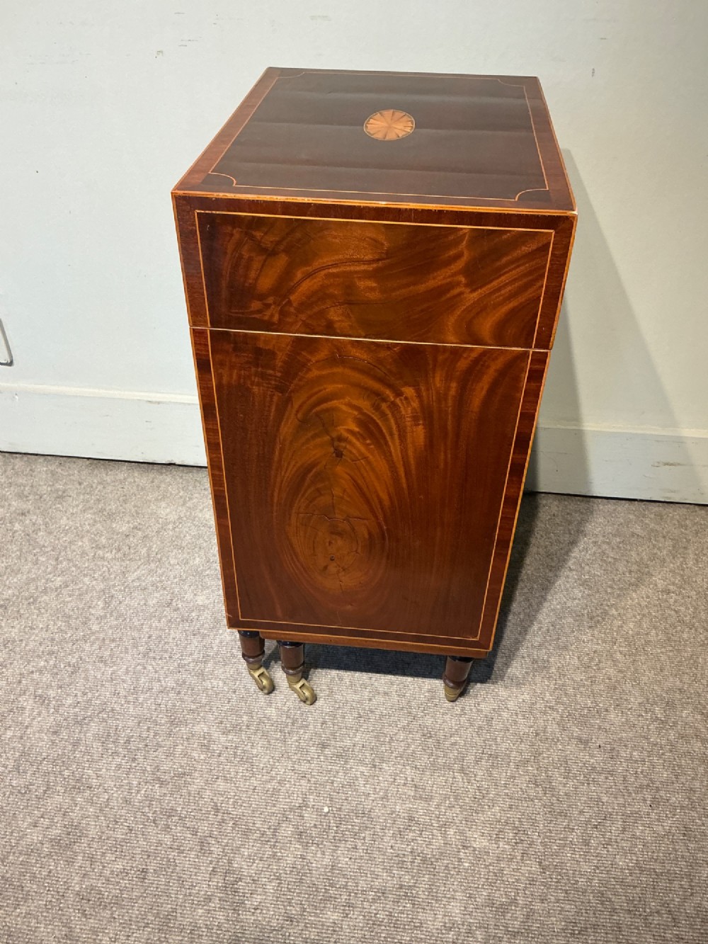 A nineteenth-century mahogany work table featuring satinwood inlay, bone escutcheons, brass ring handles, four drawer fronts, and turned legs on brass castors. View VIII
