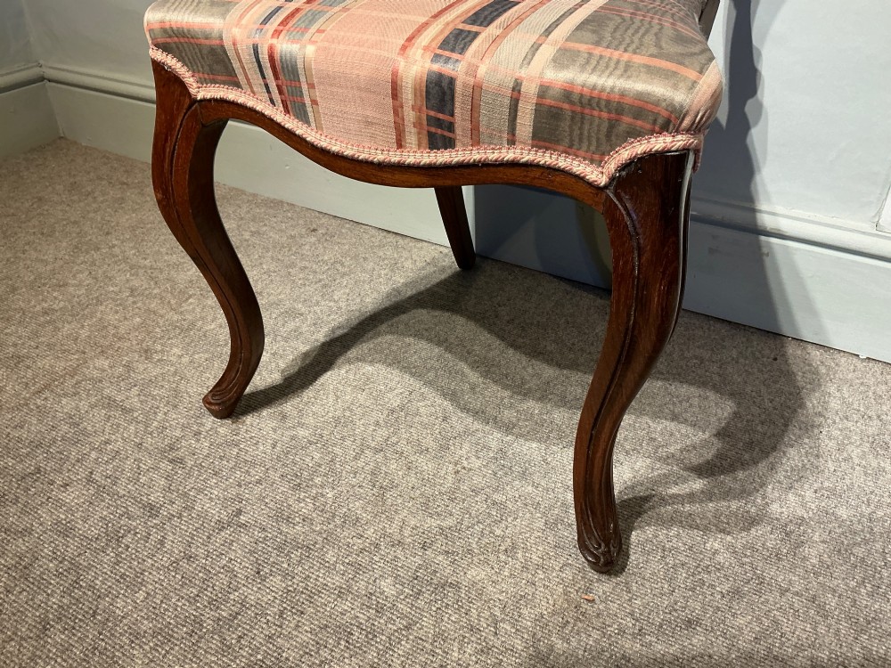 A set of six early Victorian balloon back dining chairs crafted from dark polished wood with striped upholstery. View VI